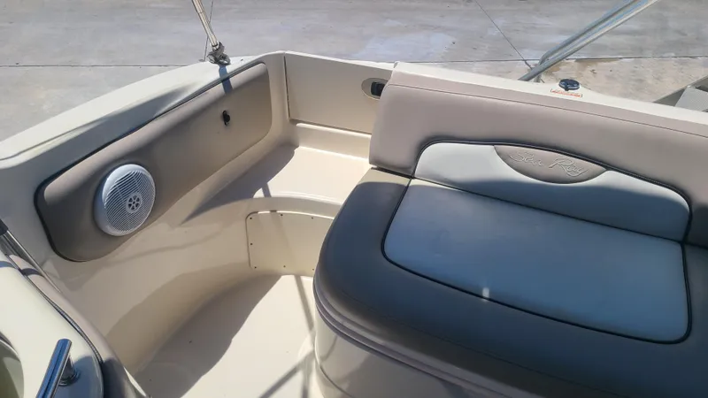 Slide: The Image of 2004 Sea Ray 270 Sundeck interior seating area with speaker. - 11