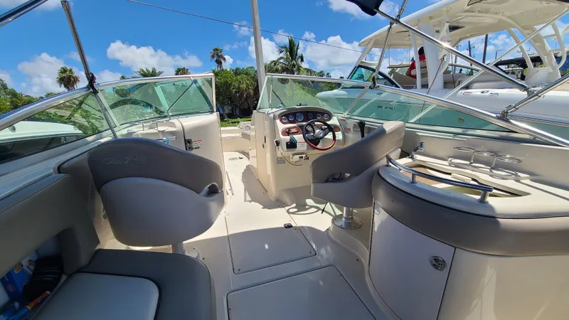 Slide: The Image of 2004 Sea Ray 270 Sundeck boat interior with helm and seating area. - 14