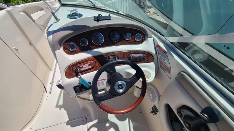 Slide: The Image of 2004 Sea Ray 270 Sundeck dashboard with steering wheel and instrument panel. - 15
