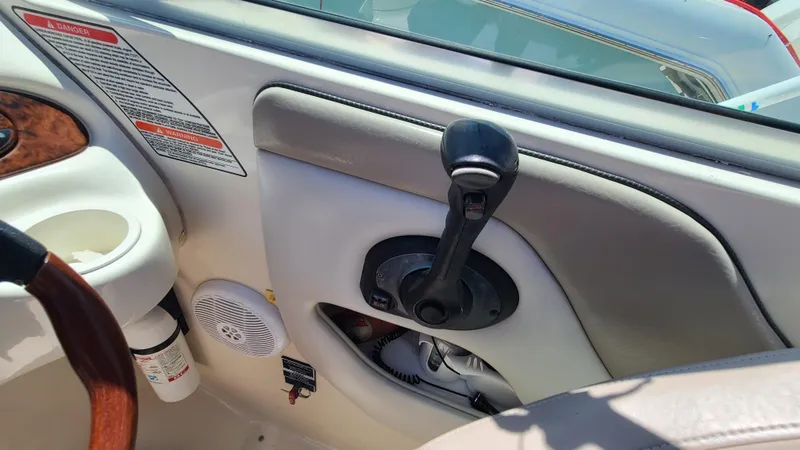 Slide: The Image of Close-up of the control panel and throttle of a 2004 Sea Ray 270 Sundeck boat. - 19