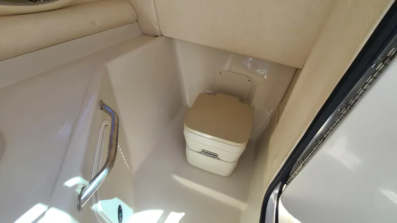 Slide: The Image of 2004 Sea Ray 270 Sundeck boat interior with portable toilet. - 20