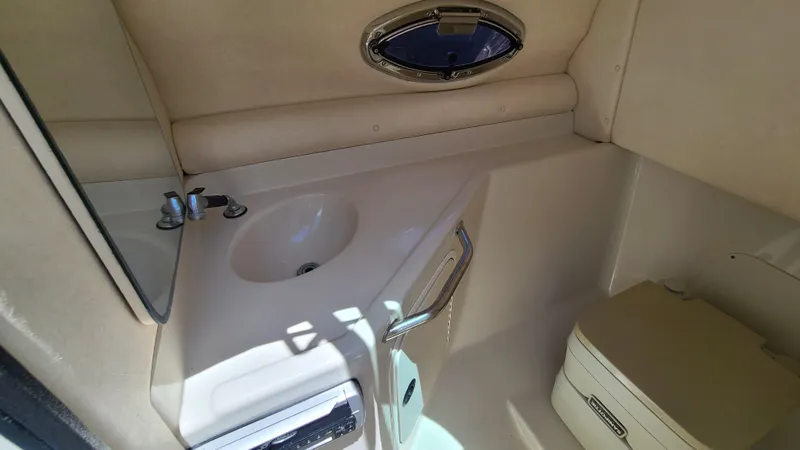Slide: The Image of 2004 Sea Ray 270 Sundeck interior bathroom with sink and toilet - 21