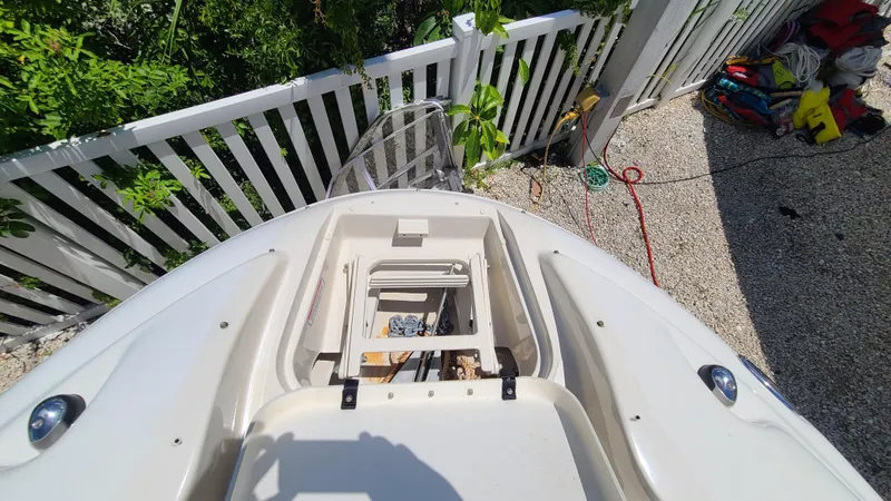 Slide: The Image of 2004 Sea Ray 270 Sundeck boat with open storage compartment. - 25