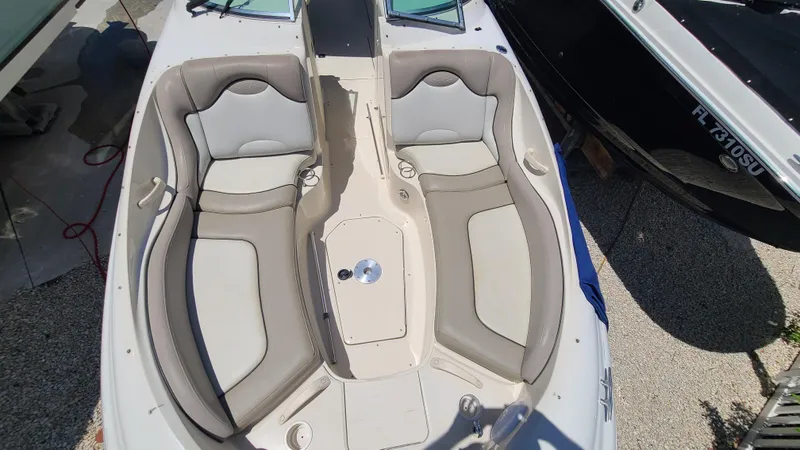 Slide: The Image of 2004 Sea Ray 270 Sundeck boat interior with dual seating and center console. - 26