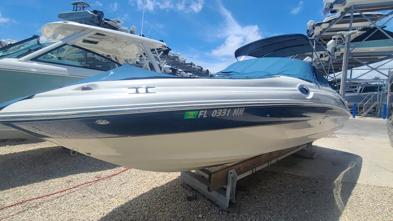 Slide: The Image of 2004 Sea Ray 270 Sundeck boat in storage, blue and white exterior. - 3