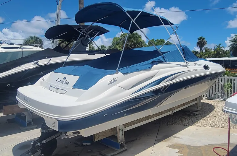 Slide: The Image of 2004 Sea Ray 270 Sundeck boat with blue canopy on a sunny day. - 33