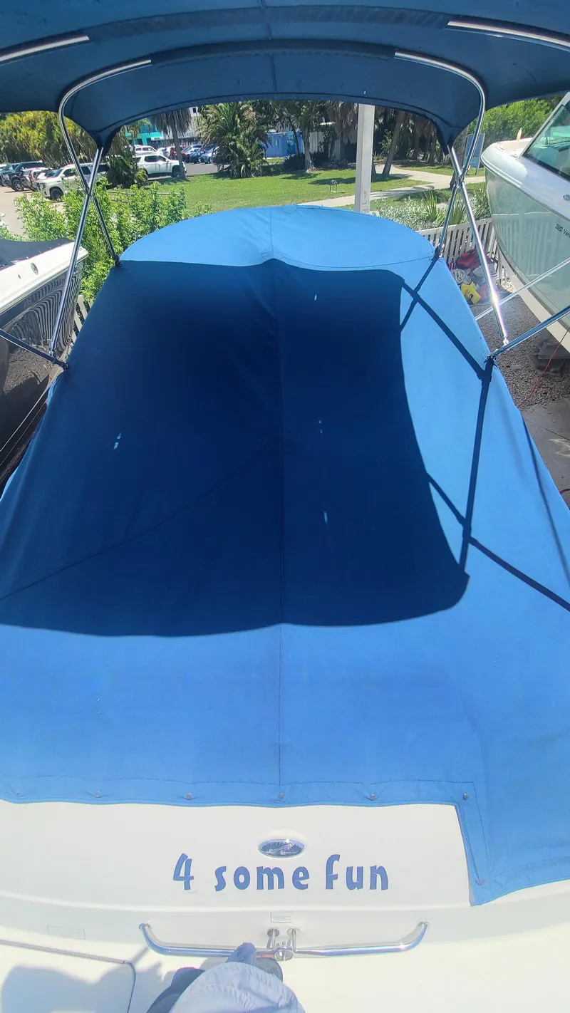 Slide: The Image of 2004 Sea Ray 270 Sundeck boat with blue cover and 4 some fun text. - 34