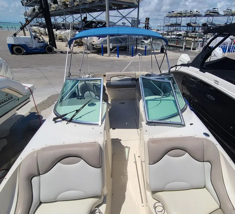 Slide: The Image of 2004 Sea Ray 270 Sundeck boat with blue bimini top docked at marina. - 8