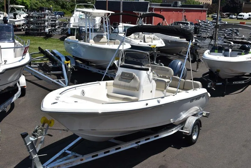 The Image of 2024 Key West 189 FS boat on a trailer in a dealership lot. - 1
