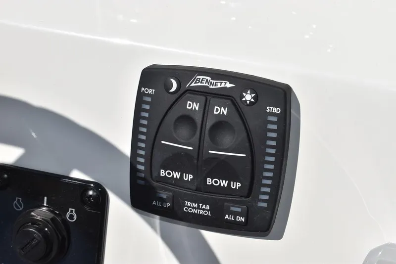 Slide: The Image of Bennett trim tab control on 2024 Key West 189 FS boat dashboard. - 14