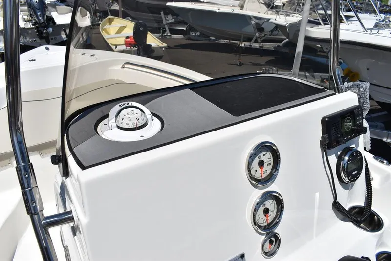 Slide: The Image of 2024 Key West 189 FS boat dashboard with gauges and compass. - 15