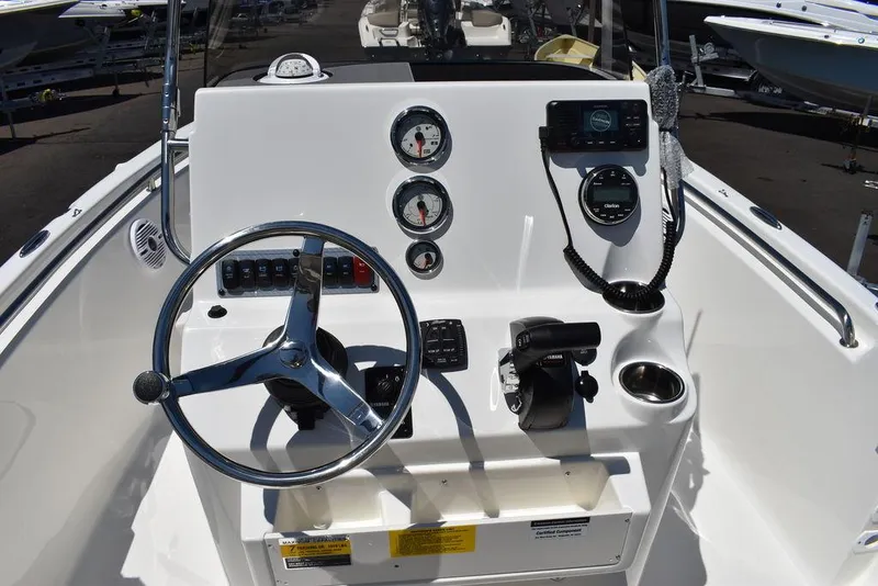 Slide: The Image of 2024 Key West 189 FS boat console with steering wheel, gauges, and controls. - 18