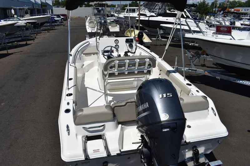 Slide: The Image of 2024 Key West 189 FS boat with Yamaha 115 engine, docked in a marina. - 6