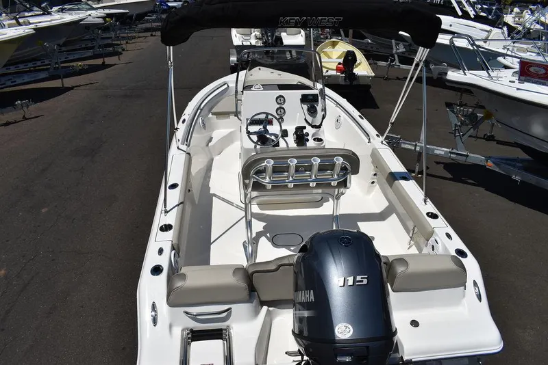Slide: The Image of 2024 Key West 189 FS boat with Yamaha 115 engine, docked in a marina. - 8