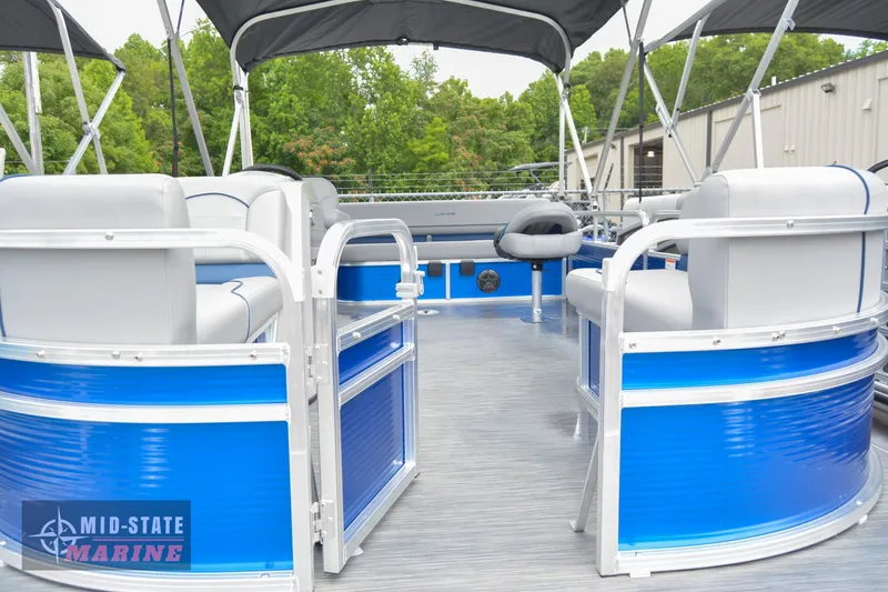 Slide: The Image of 2024 Lowe Ultra 200 Cruise pontoon boat with blue and white seating, under a canopy. - 11