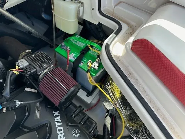 Slide: The Image of 2016 Scarab 215 HO Impulse engine compartment with battery and Rotax engine. - 13