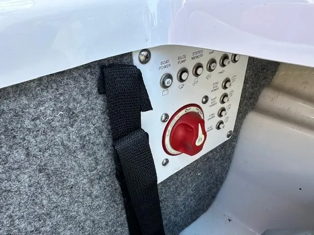 Slide: The Image of Control panel of a 2016 Scarab 215 HO Impulse boat with switches and a red dial. - 15