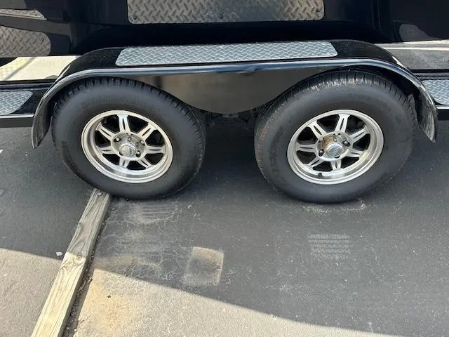 Slide: The Image of 2016 Scarab 215 HO Impulse trailer wheels on asphalt. - 20