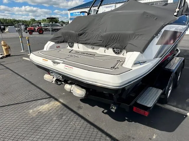 Slide: The Image of 2016 Scarab 215 HO Impulse boat with cover on trailer in a marina. - 4