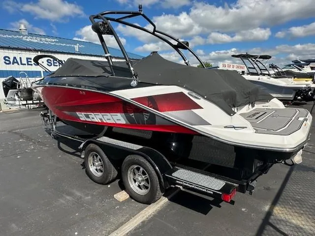 Slide: The Image of 2016 Scarab 215 HO Impulse boat on a trailer in a dealership lot. - 5