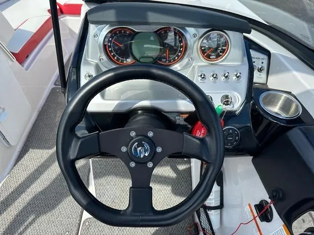 Slide: The Image of 2016 Scarab 215 HO Impulse boat dashboard with steering wheel and instrument panel. - 8