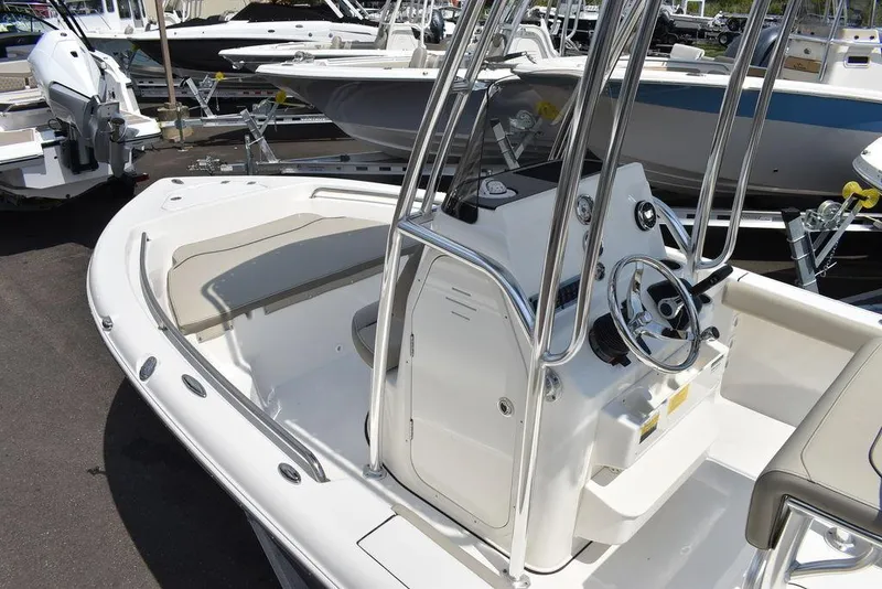 Slide: The Image of 2024 Key West 189 FS boat, sleek design, center console, docked among other boats. - 15