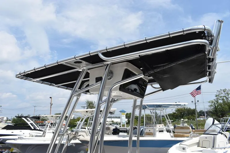 Slide: The Image of 2024 Key West 189 FS boat with T-top canopy in a marina setting. - 16