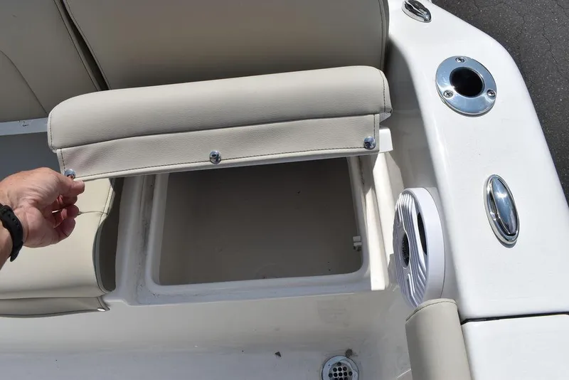 Slide: The Image of 2024 Key West 189 FS boat seat storage compartment with cup holder and speaker. - 21