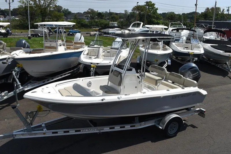Slide: The Image of 2024 Key West 189 FS boat on trailer, surrounded by other boats in a marina. - 3