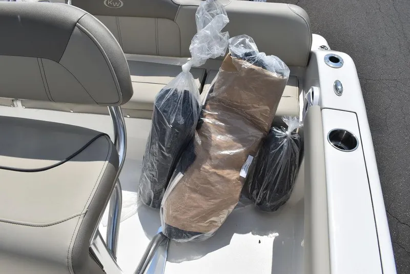 Slide: The Image of 2024 Key West 189 FS boat interior with packaged accessories on seat. - 30