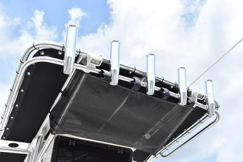 Slide: The Image of 2024 Key West 189 FS boat canopy with rod holders against a blue sky. - 38
