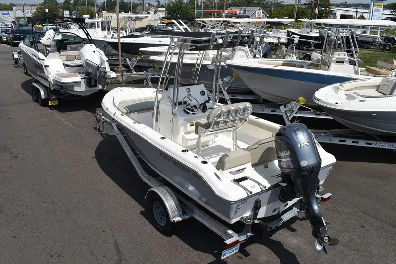 Slide: The Image of 2024 Key West 189 FS boat with outboard motor on trailer in marina. - 4