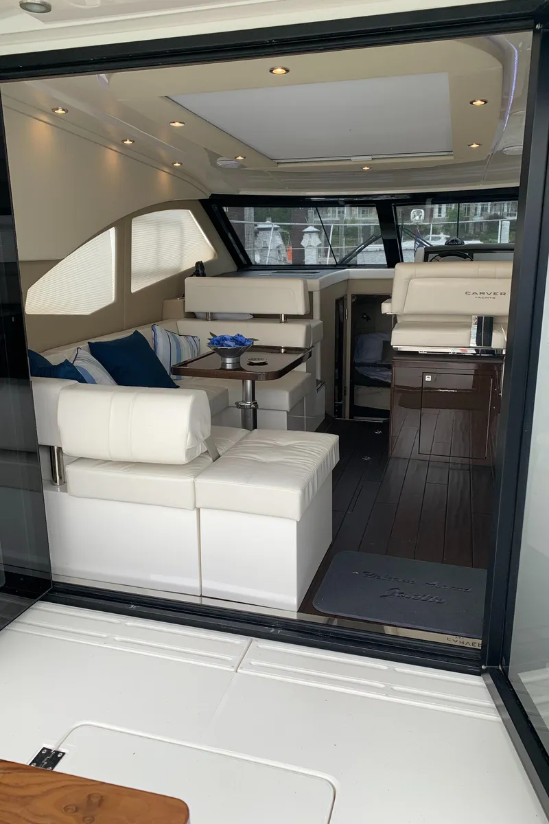 Slide: The Image of Interior of a 2020 Carver C37 Coupe yacht with modern seating and dining area. - 16