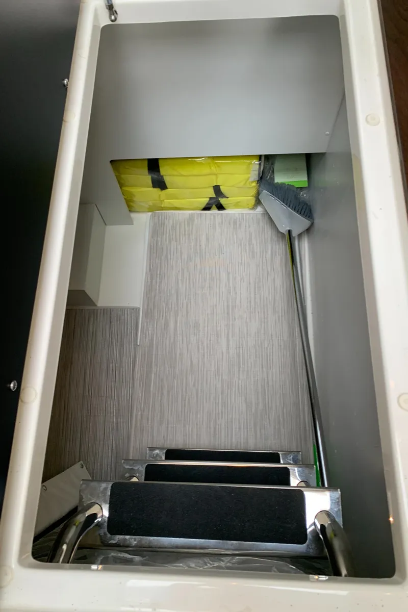 Slide: The Image of Storage compartment in 2020 Carver C37 Coupe with ladder and cleaning supplies. - 22