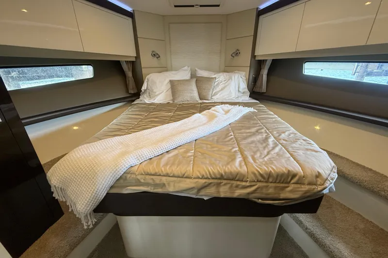 Slide: The Image of Luxurious bedroom interior of 2020 Carver C37 Coupe yacht with cozy bedding. - 34