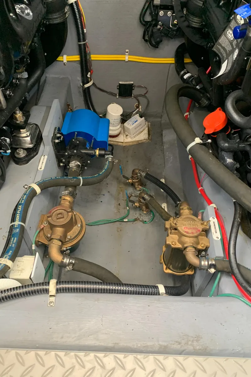 Slide: The Image of Engine compartment of a 2020 Carver C37 Coupe boat with various mechanical components. - 46