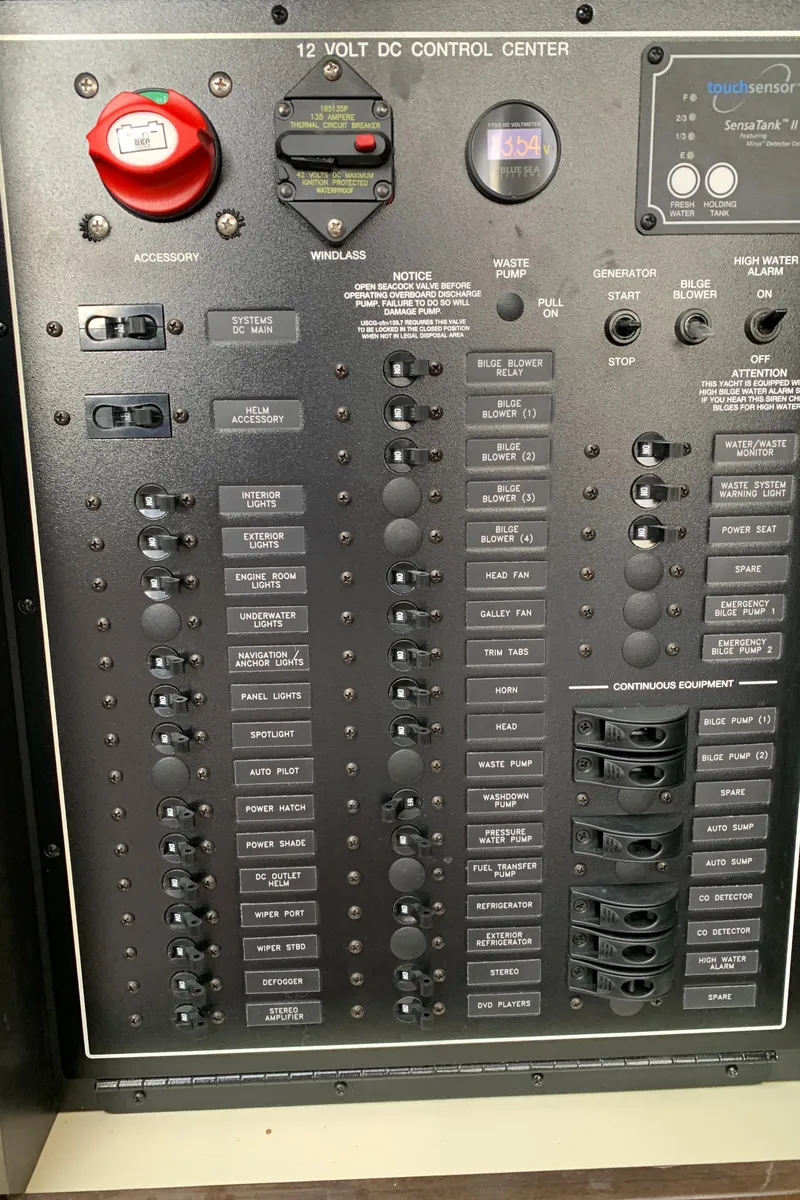 Slide: The Image of 2020 Carver C37 Coupe 12-volt DC control center panel with switches and indicators. - 51
