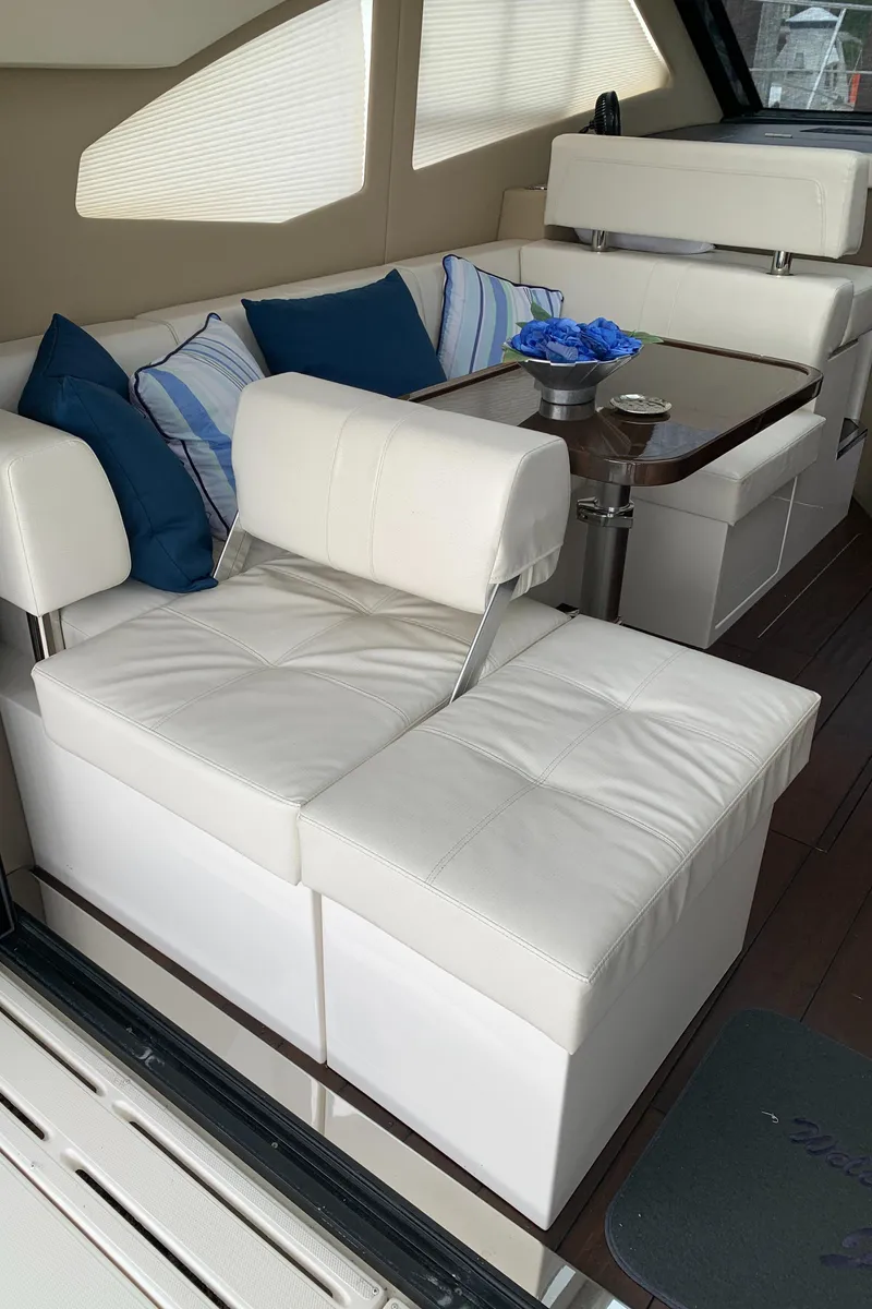 Slide: The Image of Interior seating area of a 2020 Carver C37 Coupe yacht with white leather upholstery. - 18