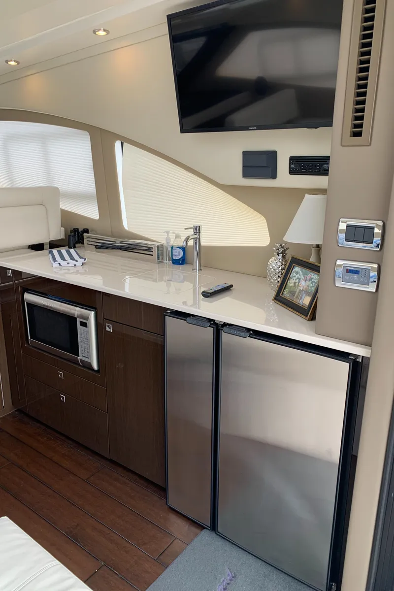 Slide: The Image of 2020 Carver C37 Coupe yacht interior with kitchenette and modern amenities. - 20