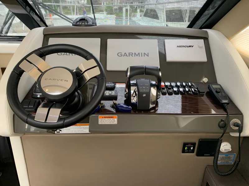 Slide: The Image of 2020 Carver C37 Coupe helm with Garmin navigation and Mercury controls. - 27