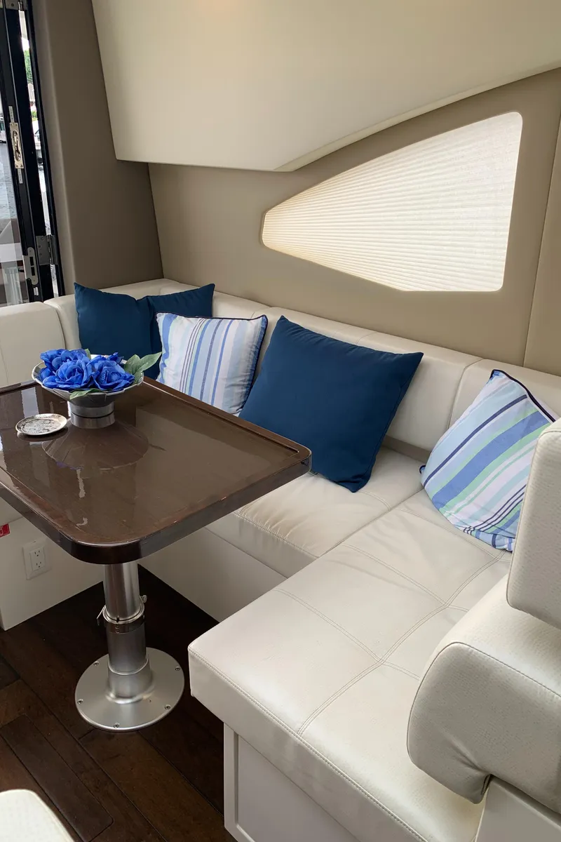 Slide: The Image of Interior of 2020 Carver C37 Coupe with white seating and blue cushions. - 29