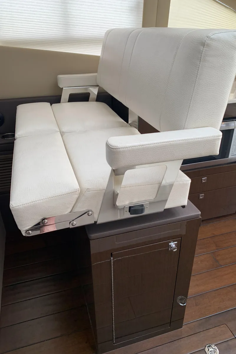 Slide: The Image of 2020 Carver C37 Coupe interior seating with white cushioned bench. - 32