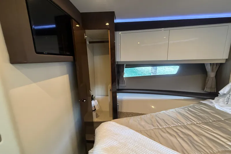 Slide: The Image of Interior of 2020 Carver C37 Coupe, featuring a cozy bedroom with modern amenities. - 38