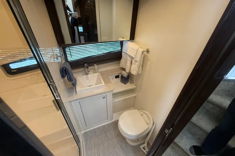 Slide: The Image of Bathroom interior of 2020 Carver C37 Coupe yacht, featuring sink, toilet, and mirror. - 41