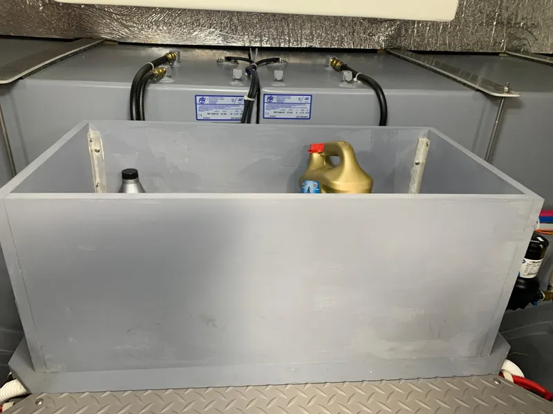 Slide: The Image of Engine compartment of a 2020 Carver C37 Coupe with storage box and oil containers. - 44