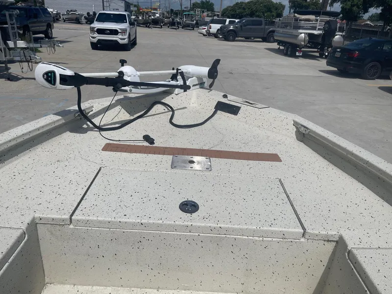 Slide: The Image of 2018 Express H20 Bay boat with trolling motor in a parking lot. - 11