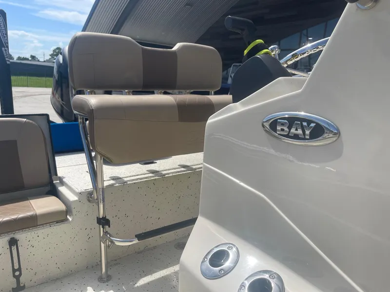 Slide: The Image of 2018 Express H20 Bay boat interior with beige seating and Bay emblem. - 14