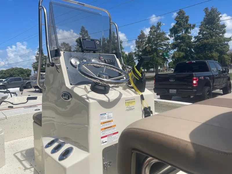 Slide: The Image of 2018 Express H20 Bay boat console with steering wheel and controls. - 16