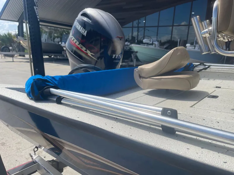 Slide: The Image of 2018 Express H20 Bay boat with Yamaha 115 engine, docked outdoors. - 18