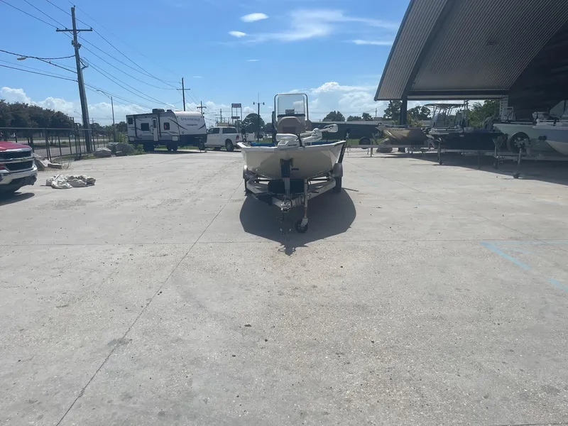 Slide: The Image of 2018 Express H20 Bay boat parked in a lot under a clear blue sky. - 2